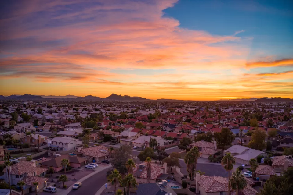 Drone view of colorful sunset over suburban neighborhood in Phoenix, Arizona